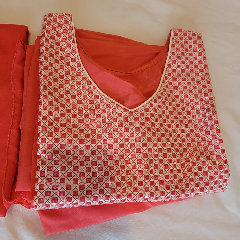 A woman already made clothes with hand made embroidery work on the dress. - Picture 2 of 8